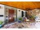 Charming front porch featuring flagstone flooring, a wooden ceiling, and a cozy seating area at 2707 Anderson Drive Dr, Raleigh, NC 27608