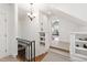 Upstairs hallway with decorative lighting and staircase with a railing, leading to carpeted floors in an open space at 2707 Anderson Drive Dr, Raleigh, NC 27608
