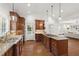 Well-lit kitchen with wooden cabinetry, stainless steel appliances, granite countertops and a center island at 2707 Anderson Drive Dr, Raleigh, NC 27608