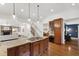 Open-concept kitchen featuring a center island, granite countertops, and hardwood floors at 2707 Anderson Drive Dr, Raleigh, NC 27608