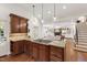Gourmet kitchen features an island with a gas cooktop and flows into the living room with a fireplace at 2707 Anderson Drive Dr, Raleigh, NC 27608