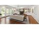 Inviting living room with white sofa, armchairs, and a wall of windows leading to the backyard at 2707 Anderson Drive Dr, Raleigh, NC 27608
