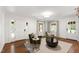 Bright living room with hardwood floors, white walls, neutral rug, and two green accent chairs at 2707 Anderson Drive Dr, Raleigh, NC 27608