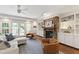 Bright and airy living room with a stone fireplace, built-in shelves, and French doors at 2707 Anderson Drive Dr, Raleigh, NC 27608