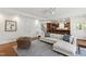 Bright, open living room featuring hardwood floors, stylish furnishings, and seamless flow to the kitchen at 2707 Anderson Drive Dr, Raleigh, NC 27608