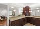 Bathroom features dual vanities, granite counters, wood cabinets, and a large mirror at 2707 Anderson Drive Dr, Raleigh, NC 27608