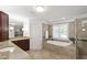 Spa-like bathroom with a soaking tub, walk-in shower, dual vanities, and tiled walls at 2707 Anderson Drive Dr, Raleigh, NC 27608