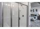 Elegant tiled shower with a glass door and built-in bench that connects to main bedroom at 276 Fosterton Cottage Way, Raleigh, NC 27603