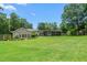 Spacious backyard with lush green grass and mature trees, offering plenty of room for outdoor activities at 2816 Keck Dr, Burlington, NC 27215