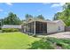 Exterior of the home featuring screened-in porch, well maintained lawn, and landscaping at 2816 Keck Dr, Burlington, NC 27215