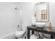 Bathroom with a white vessel sink and shower-tub combination featuring subway tile at 2816 Keck Dr, Burlington, NC 27215