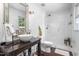 Bathroom with a modern vessel sink and a glass-enclosed shower featuring subway tile and herringbone floors at 2816 Keck Dr, Burlington, NC 27215