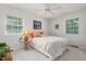 Bright bedroom with two windows and a ceiling fan, offering a comfortable and airy space at 2816 Keck Dr, Burlington, NC 27215