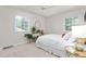 Well-lit bedroom with two windows, a ceiling fan, and a cozy ambiance with a neutral color scheme at 2816 Keck Dr, Burlington, NC 27215
