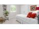 Cozy bedroom featuring a white bed, houseplant, and natural light from a window at 2816 Keck Dr, Burlington, NC 27215