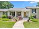 Charming home with rocking chairs on the porch and a well-manicured lawn at 2816 Keck Dr, Burlington, NC 27215