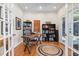 Well-lit home office with hardwood floors, bookshelves, and double doors at 2816 Keck Dr, Burlington, NC 27215