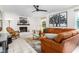 Bright living room with fireplace, leather sofa, and decorative tree art on the wall at 2816 Keck Dr, Burlington, NC 27215