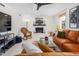 Inviting living room with a brick fireplace, a comfortable leather sofa, and tile floors at 2816 Keck Dr, Burlington, NC 27215