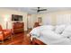 Sunlit bedroom features wood floors, comfortable seating, and a ceiling fan at 2816 Keck Dr, Burlington, NC 27215