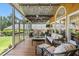 Inviting screened porch features comfortable seating, string lights, and a ceiling fan at 2816 Keck Dr, Burlington, NC 27215