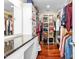 Spacious walk-in closet with custom shelving, countertop, and hardwood floors at 2816 Keck Dr, Burlington, NC 27215