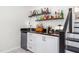 Home wet bar area featuring granite countertop, mini fridge, and storage at 2816 Keck Dr, Burlington, NC 27215