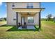 Back patio featuring a ceiling fan, an outdoor seating area, and a grassy backyard at 2998 Matthews Mill Pond Rd, Angier, NC 27501