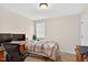 Bedroom featuring a neutral color palette, a window, and a wooden writing desk at 2998 Matthews Mill Pond Rd, Angier, NC 27501