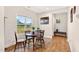 Inviting dining area features hardwood floors, a round wooden table, and a sunlit window at 2998 Matthews Mill Pond Rd, Angier, NC 27501