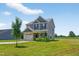 Exterior view of a two-story home with an attached garage and a green lawn at 2998 Matthews Mill Pond Rd, Angier, NC 27501
