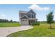Two-story home boasts a well-manicured lawn, attached garage, and a neatly paved driveway at 2998 Matthews Mill Pond Rd, Angier, NC 27501
