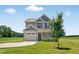 Charming two-story home features a neutral exterior, attached garage, and well-maintained lawn at 2998 Matthews Mill Pond Rd, Angier, NC 27501