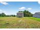 Exterior view of home with neutral siding, and a spacious grassy backyard at 2998 Matthews Mill Pond Rd, Angier, NC 27501