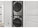 Efficiently stacked silver washer and dryer laundry units in a utility closet at 2998 Matthews Mill Pond Rd, Angier, NC 27501