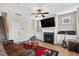 Relaxing living room with a fireplace, ceiling fan, and a comfortable leather sofa at 2998 Matthews Mill Pond Rd, Angier, NC 27501