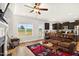 Open-concept living area with view of a field, kitchen, and fireplace with mounted TV at 2998 Matthews Mill Pond Rd, Angier, NC 27501