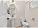 Cozy powder room with pedestal sink, oval mirror, and natural lighting at 2998 Matthews Mill Pond Rd, Angier, NC 27501