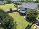 Aerial view of a fenced backyard and house with a screened-in porch and landscaped lawn at 300 Stobhill Ln, Holly Springs, NC 27540