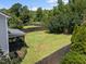Large backyard with a well-maintained lawn, wooden fence, and screened-in porch at 300 Stobhill Ln, Holly Springs, NC 27540