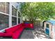 Inviting backyard patio with comfortable red lounge seating and a charming playhouse at 300 Stobhill Ln, Holly Springs, NC 27540