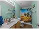 Bright bathroom featuring a vanity with solid surface top, toilet, and shower with tropical-themed curtain at 300 Stobhill Ln, Holly Springs, NC 27540