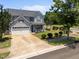 Beautiful two-story home features a well-manicured lawn and a long driveway for easy parking at 300 Stobhill Ln, Holly Springs, NC 27540