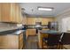 Kitchen featuring an island with counter seating, light cabinetry, stainless steel appliances, and updated fixtures at 300 Stobhill Ln, Holly Springs, NC 27540