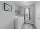 Well-lit laundry room featuring a washer and dryer and built-in shelving for optimal organization at 300 Stobhill Ln, Holly Springs, NC 27540