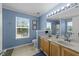 Main bathroom featuring double sink vanity, large mirror, and ample natural light at 300 Stobhill Ln, Holly Springs, NC 27540