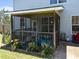 Screened porch featuring a variety of outdoor toys and a beautiful flower garden at 300 Stobhill Ln, Holly Springs, NC 27540