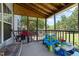 Covered porch featuring wooden beams, screened enclosure, and outdoor play area for  at 300 Stobhill Ln, Holly Springs, NC 27540