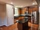 Modern kitchen featuring stainless steel appliances, dark countertops, kitchen island and hardwood flooring at 302 Glenview Ln, Durham, NC 27703