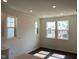 Bright dining area with hardwood floors and multiple windows allowing ample natural light at 3113 White Blossom Ct, Raleigh, NC 27610